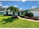 Beautifully landscaped front yard with a well-maintained lawn and inviting walkway to the front door at 913 64Th W St, Bradenton, FL 34209
