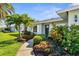 Landscaped front yard with lush tropical plants and a welcoming walkway to the front door at 913 64Th W St, Bradenton, FL 34209