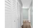 Hallway with hardwood floors and white closet doors at 913 64Th W St, Bradenton, FL 34209