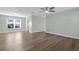 Open living room with a ceiling fan, gray walls, wood-look floors, and natural light at 913 64Th W St, Bradenton, FL 34209