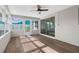 Bright sun room featuring multiple windows, fan, and sliding glass doors at 913 64Th W St, Bradenton, FL 34209