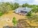 Back of house and deck featuring fire pit area from an aerial perspective at 10001 289Th E St, Myakka City, FL 34251