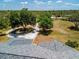Overhead view of a property featuring mature trees, an extended driveway and an open landscape at 10001 289Th E St, Myakka City, FL 34251