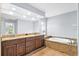 Bathroom featuring double vanity, granite counters, and large soaking tub at 10001 289Th E St, Myakka City, FL 34251
