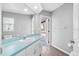 Bright bathroom featuring a blue countertop, white cabinetry, and a view to the outdoor deck at 10001 289Th E St, Myakka City, FL 34251