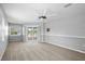 Spacious bedroom with carpet floor, ceiling fan, sliding doors that lead to a deck, and windows offering natural light at 10001 289Th E St, Myakka City, FL 34251