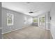 Bedroom with a ceiling fan, neutral walls, a sliding glass door to the back patio and two bright windows at 10001 289Th E St, Myakka City, FL 34251