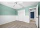 Bedroom with a double closet, carpet, and painted green walls at 10001 289Th E St, Myakka City, FL 34251