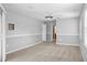Neutral carpeted bedroom featuring a ceiling fan and gray walls at 10001 289Th E St, Myakka City, FL 34251