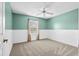 Bedroom features a window, neutral carpet, and wainscoting at 10001 289Th E St, Myakka City, FL 34251