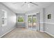 Bright bedroom with neutral carpet and sliding door access to a deck at 10001 289Th E St, Myakka City, FL 34251