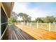 Spacious wooden deck offering views of the backyard and fire pit area at 10001 289Th E St, Myakka City, FL 34251