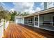 Wide wood deck that overlooks the screened porch and backyard, perfect for relaxation and entertainment at 10001 289Th E St, Myakka City, FL 34251