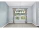 Cozy dining room with a stylish chandelier above a large window dressed with elegant curtains, and carpeted floor at 10001 289Th E St, Myakka City, FL 34251