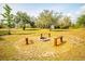 Scenic backyard fire pit surrounded by gravel, creating a cozy outdoor retreat at 10001 289Th E St, Myakka City, FL 34251