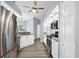 Modern kitchen with stainless steel appliances, granite countertops, white cabinetry, laminate flooring, and ample lighting at 10001 289Th E St, Myakka City, FL 34251