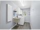 Functional laundry room with a utility sink, washer and dryer, storage cabinets, and laminate flooring at 10001 289Th E St, Myakka City, FL 34251