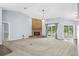Spacious living room with a stone fireplace, ceiling fan, carpeted floor and sliding doors to the outdoor space at 10001 289Th E St, Myakka City, FL 34251