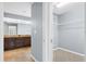 View of walk-in closet with adjustable shelving across from the bathroom at 10001 289Th E St, Myakka City, FL 34251