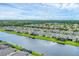Houses and a pond in a scenic community aerial view at 1017 Fernleaf Run, Bradenton, FL 34212
