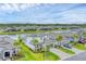 Aerial view of a two-story home with a well-manicured lawn by a lake at 1017 Fernleaf Run, Bradenton, FL 34212