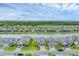 Aerial view showcases lovely waterfront homes with manicured lawns in this desirable neighborhood at 1017 Fernleaf Run, Bradenton, FL 34212
