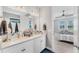 Bright bathroom featuring a double vanity and view to bedroom at 1017 Fernleaf Run, Bradenton, FL 34212