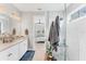 Bathroom with marble shower, double vanity, and view to bedroom at 1017 Fernleaf Run, Bradenton, FL 34212