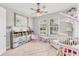 Bright bedroom with two windows, a neutral color scheme, and a comfortable area for playing at 1017 Fernleaf Run, Bradenton, FL 34212