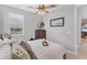 This neutrally decorated bedroom includes a ceiling fan and dresser at 1017 Fernleaf Run, Bradenton, FL 34212