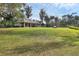 Scenic view of a community pavilion nestled in a lush, green landscape with mature trees at 1017 Fernleaf Run, Bradenton, FL 34212
