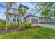 Beautiful two-story home with a well-manicured lawn, tropical landscaping and a two-car garage at 1017 Fernleaf Run, Bradenton, FL 34212