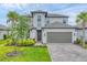 Two-story home with a well-manicured lawn and a two-car garage at 1017 Fernleaf Run, Bradenton, FL 34212