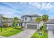 Two-story home with well manicured lawn and a two car garage at 1017 Fernleaf Run, Bradenton, FL 34212