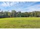 Serene green space with a bench, offering peaceful views of the surrounding nature and water at 1017 Fernleaf Run, Bradenton, FL 34212
