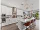 Stylish kitchen with white cabinets, stainless steel appliances, and an island with seating at 1017 Fernleaf Run, Bradenton, FL 34212