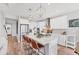 Modern kitchen with white cabinets, stainless steel appliances, and a large island at 1017 Fernleaf Run, Bradenton, FL 34212