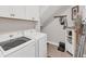 The laundry room includes a front loading washer and dryer and accent lighting at 1017 Fernleaf Run, Bradenton, FL 34212