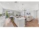 Bright living room with hardwood floors, modern island, and open floor plan at 1017 Fernleaf Run, Bradenton, FL 34212
