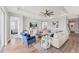 Bright and airy living room featuring a ceiling fan and hardwood floors at 1017 Fernleaf Run, Bradenton, FL 34212