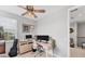 This home office features neutral walls, a large window, ceiling fan with light, and multiple computer monitors at 1017 Fernleaf Run, Bradenton, FL 34212