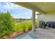 Outdoor patio features pavers, lush landscaping, and a view of the community lake at 1017 Fernleaf Run, Bradenton, FL 34212