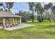 Inviting pavilion with ample seating, set against a backdrop of lush greenery and mature trees at 1017 Fernleaf Run, Bradenton, FL 34212