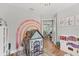 Fun playroom with a rainbow mural, play kitchen, and a playhouse, perfect for children at 1017 Fernleaf Run, Bradenton, FL 34212