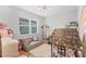 Well-lit playroom with house-shaped tent, comfortable sofa, and a view from the window at 1017 Fernleaf Run, Bradenton, FL 34212