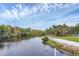 Scenic river view showcasing lush trees along the bank, a tranquil river, and kayaks for fun outdoors at 1017 Fernleaf Run, Bradenton, FL 34212