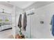Shower area featuring marble tile, glass surround, and view to bedroom at 1017 Fernleaf Run, Bradenton, FL 34212