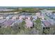 Aerial view of a neighborhood with mature trees and a water feature at 12091 Firewheel Pl, Venice, FL 34293