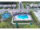 Stunning aerial view of the community pool, bocce ball court, and tennis courts at Preserve at West Villages at 12091 Firewheel Pl, Venice, FL 34293