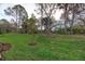 Lush green backyard with mature trees, offering a private and tranquil outdoor space at 12091 Firewheel Pl, Venice, FL 34293